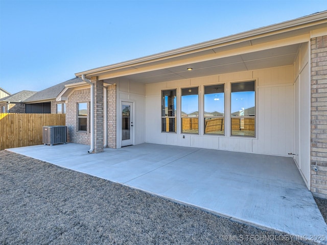 back of house featuring cooling unit and a patio area