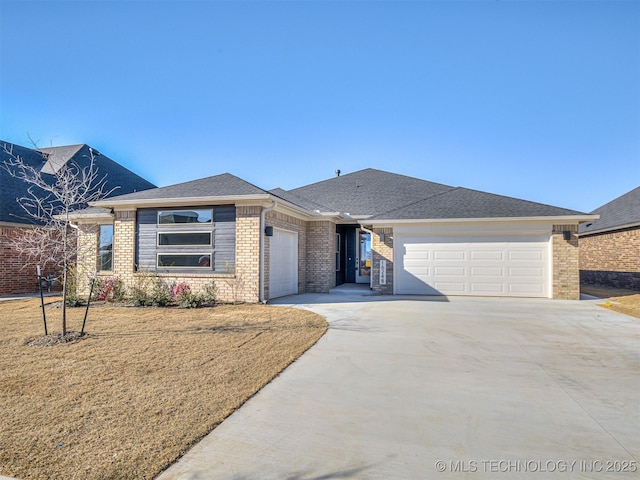 view of front of property featuring a garage and a front lawn