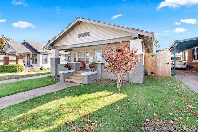 view of front of house with covered porch and a front yard