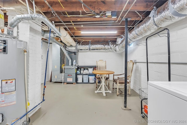 basement with washer / dryer, gas water heater, and heating unit