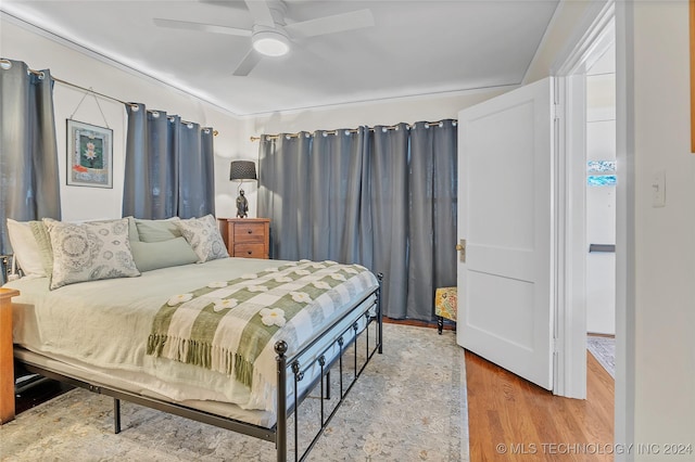 bedroom with hardwood / wood-style floors and ceiling fan