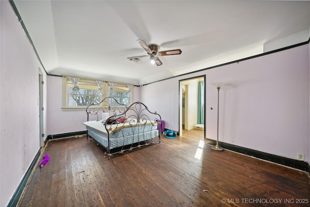 unfurnished bedroom featuring hardwood / wood-style flooring, a ceiling fan, and baseboards