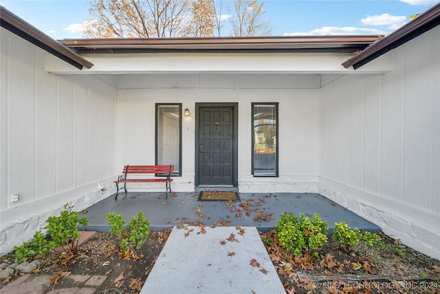 view of exterior entry featuring a porch