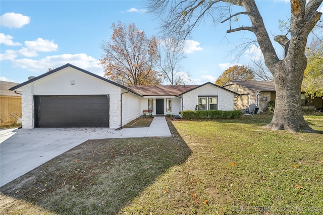 ranch-style house with a front lawn and a garage