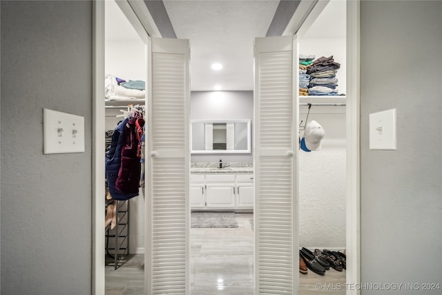 hall featuring sink and light wood-type flooring