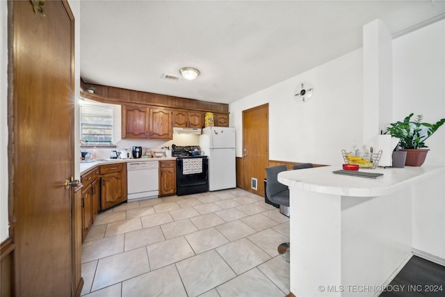 kitchen with kitchen peninsula, white appliances, and sink