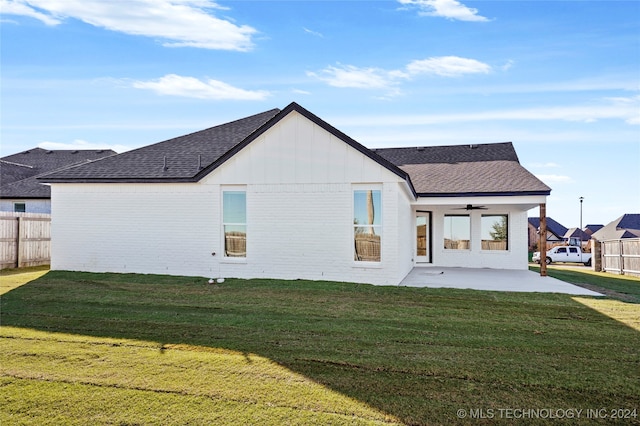 back of house with a yard, a patio, and ceiling fan