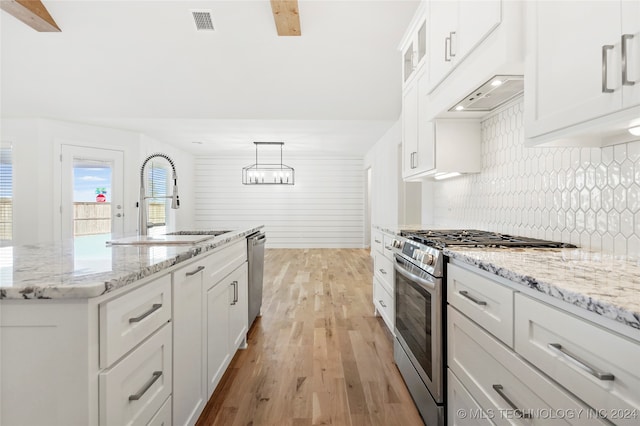 kitchen featuring white cabinetry, pendant lighting, and stainless steel appliances