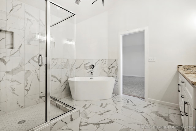 bathroom featuring vanity and shower with separate bathtub