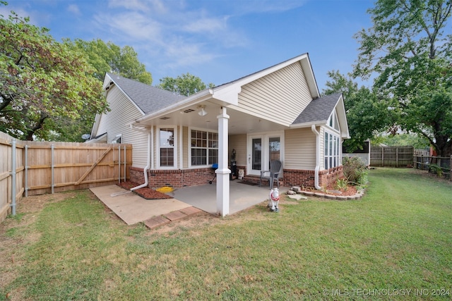 rear view of property with a lawn and a patio area