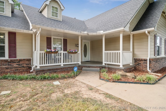 view of exterior entry featuring a porch