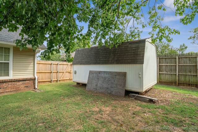 view of outdoor structure featuring a lawn