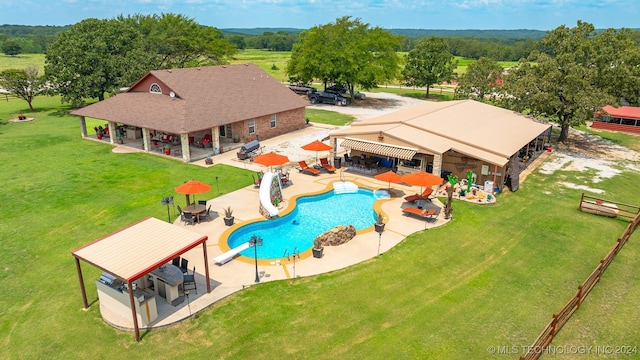 view of pool with a patio and a water slide