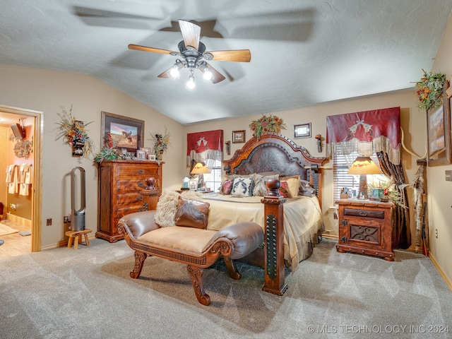 carpeted bedroom featuring multiple windows, connected bathroom, vaulted ceiling, and ceiling fan