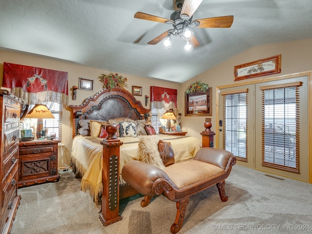 carpeted bedroom featuring ceiling fan, lofted ceiling, access to outside, and multiple windows