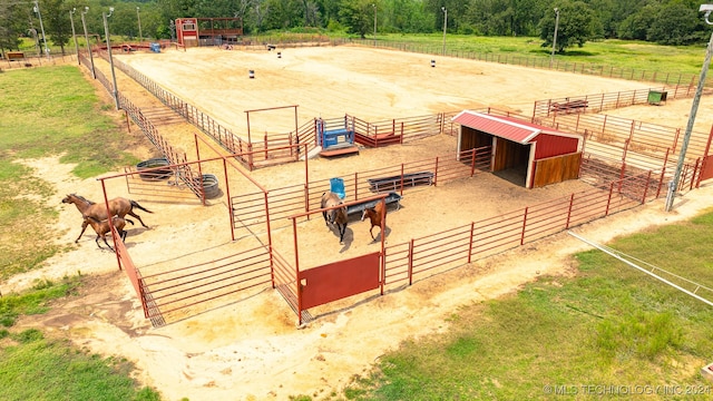 view of horse barn featuring a rural view