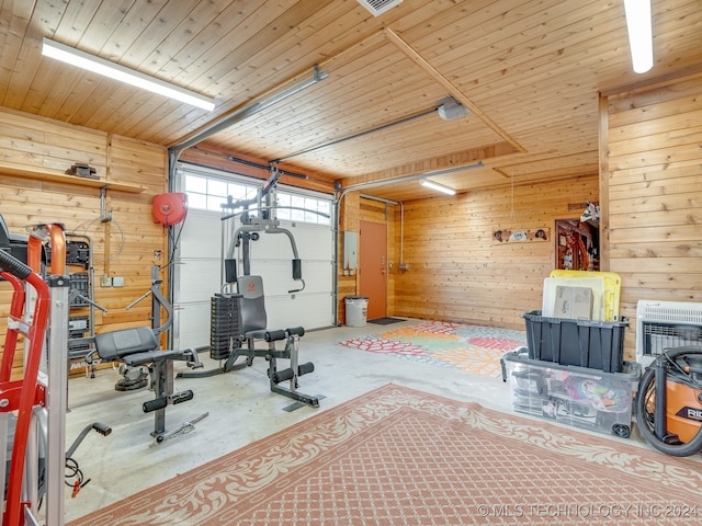 workout room featuring wood ceiling and wood walls