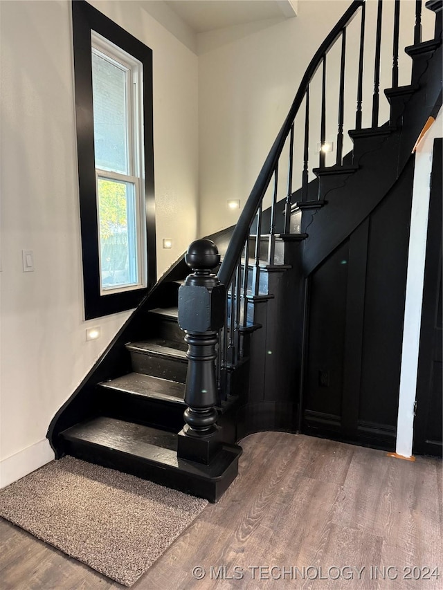 stairs with hardwood / wood-style flooring