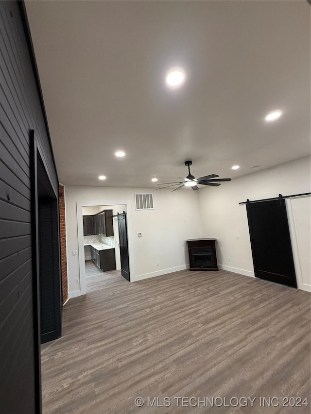 unfurnished living room featuring hardwood / wood-style floors and ceiling fan