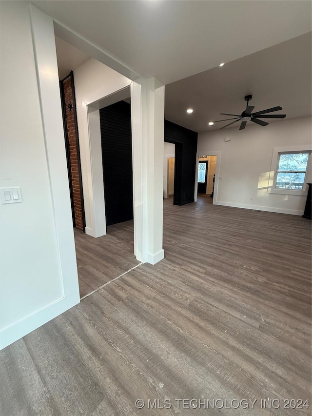 unfurnished living room featuring ceiling fan and hardwood / wood-style floors