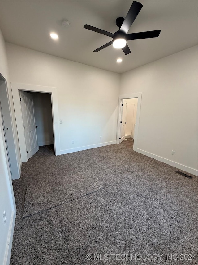 carpeted spare room with ceiling fan