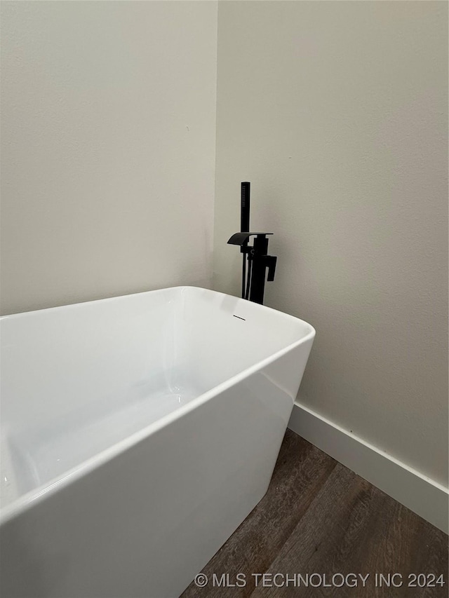 bathroom featuring hardwood / wood-style flooring and a bathing tub