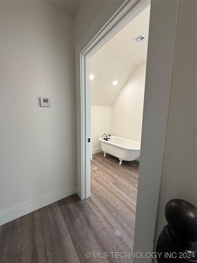 bathroom featuring a bath and hardwood / wood-style floors