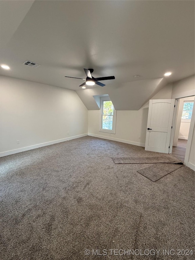 bonus room with ceiling fan, carpet floors, and vaulted ceiling