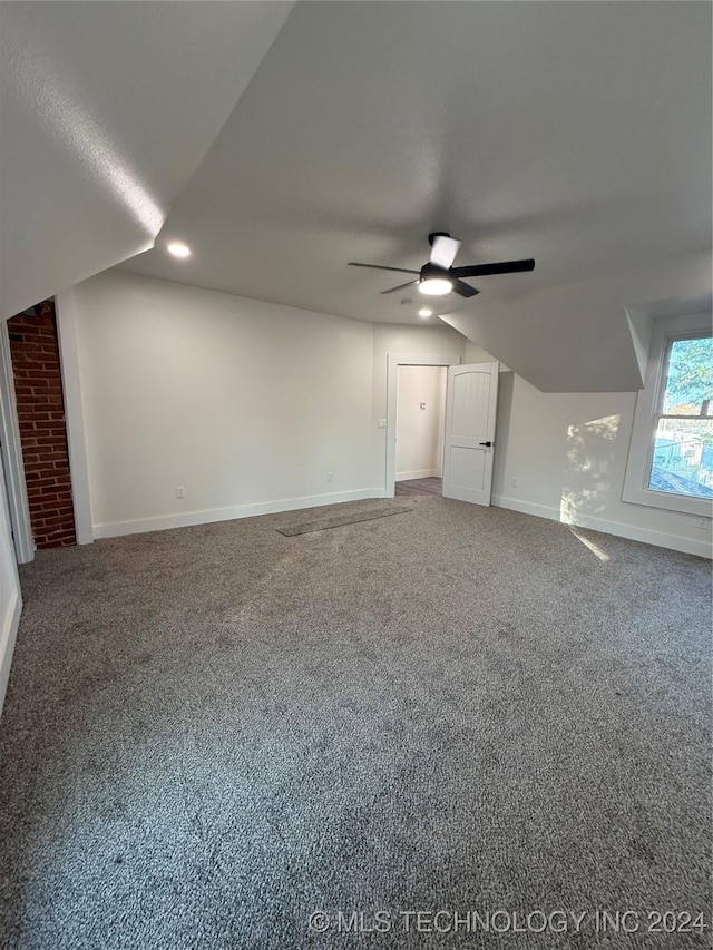 additional living space featuring ceiling fan, carpet floors, and lofted ceiling