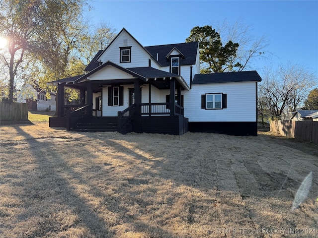 view of front of house featuring covered porch and a front lawn