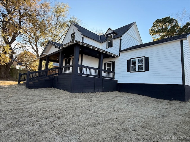 rear view of house with covered porch