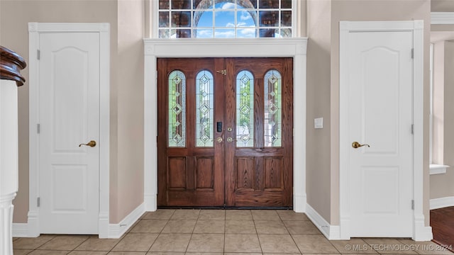 tiled entrance foyer featuring a wealth of natural light and french doors