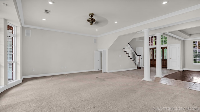 unfurnished living room featuring light carpet, ornate columns, ceiling fan, and crown molding