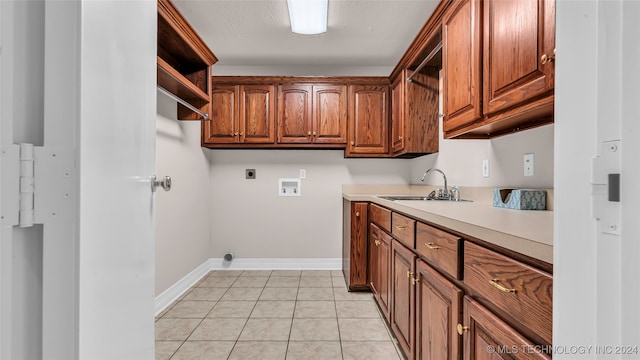 clothes washing area with cabinets, hookup for a washing machine, electric dryer hookup, sink, and light tile patterned flooring