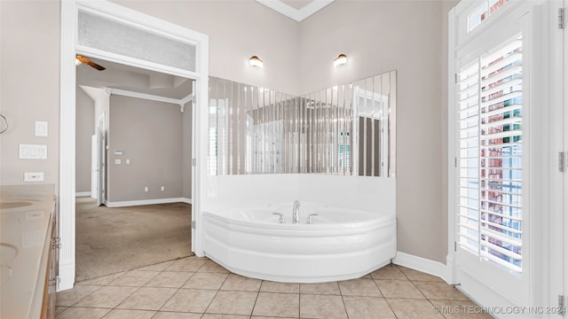 bathroom featuring tile patterned floors, ceiling fan, a tub to relax in, and vanity