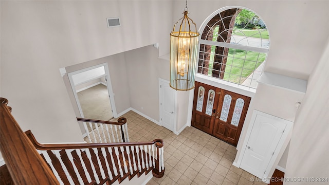 entryway featuring a chandelier and a high ceiling