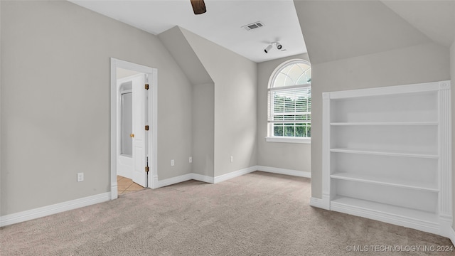 additional living space with light carpet, ceiling fan, and lofted ceiling