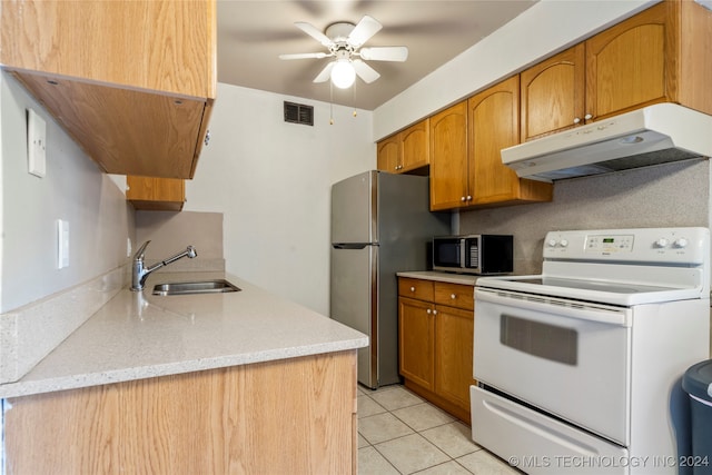 kitchen with sink, ceiling fan, light tile patterned floors, appliances with stainless steel finishes, and light stone counters