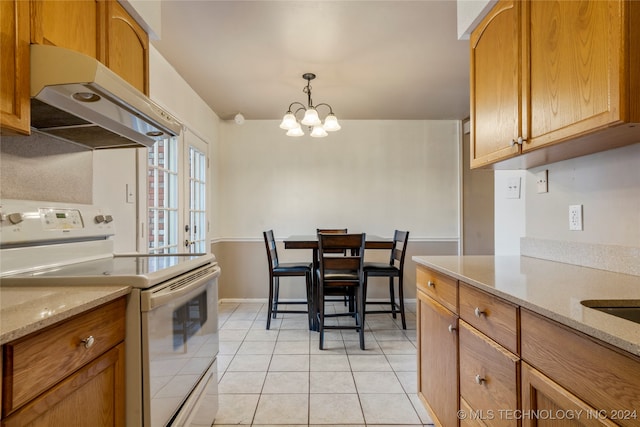 kitchen featuring light stone counters, decorative light fixtures, white electric stove, a chandelier, and light tile patterned flooring