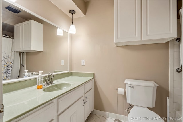 bathroom featuring tile patterned flooring, vanity, and toilet