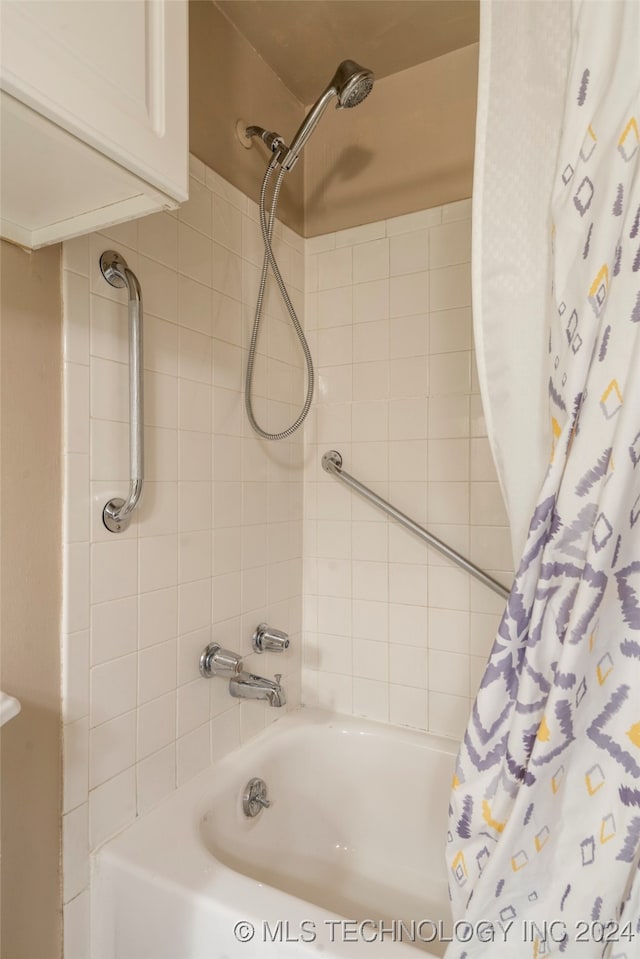 bathroom featuring shower / bath combo with shower curtain