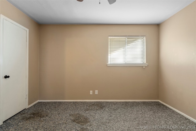 empty room with ceiling fan and carpet floors