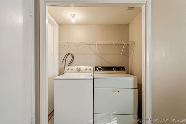 clothes washing area featuring washer and dryer