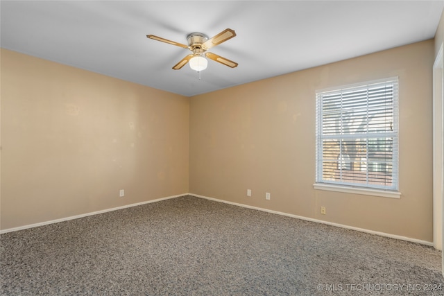 spare room featuring ceiling fan and carpet floors