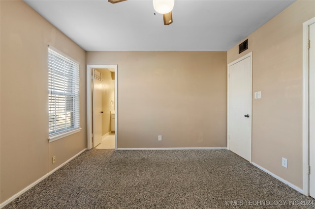 carpeted empty room featuring ceiling fan