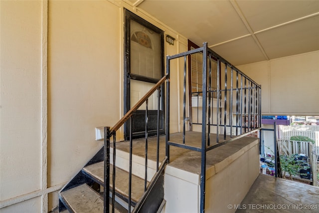 stairs with concrete flooring