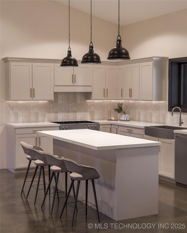 kitchen with sink, decorative light fixtures, backsplash, and a kitchen island