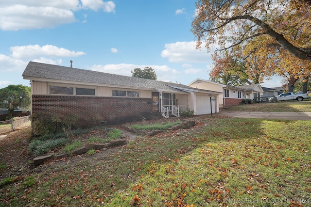 ranch-style home with a front lawn and a garage