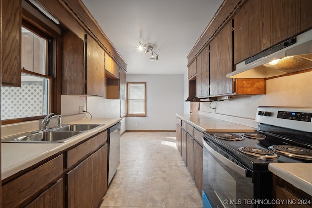 kitchen with dark brown cabinetry, extractor fan, sink, and appliances with stainless steel finishes