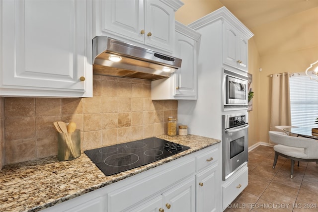 kitchen with appliances with stainless steel finishes, white cabinetry, and light stone counters